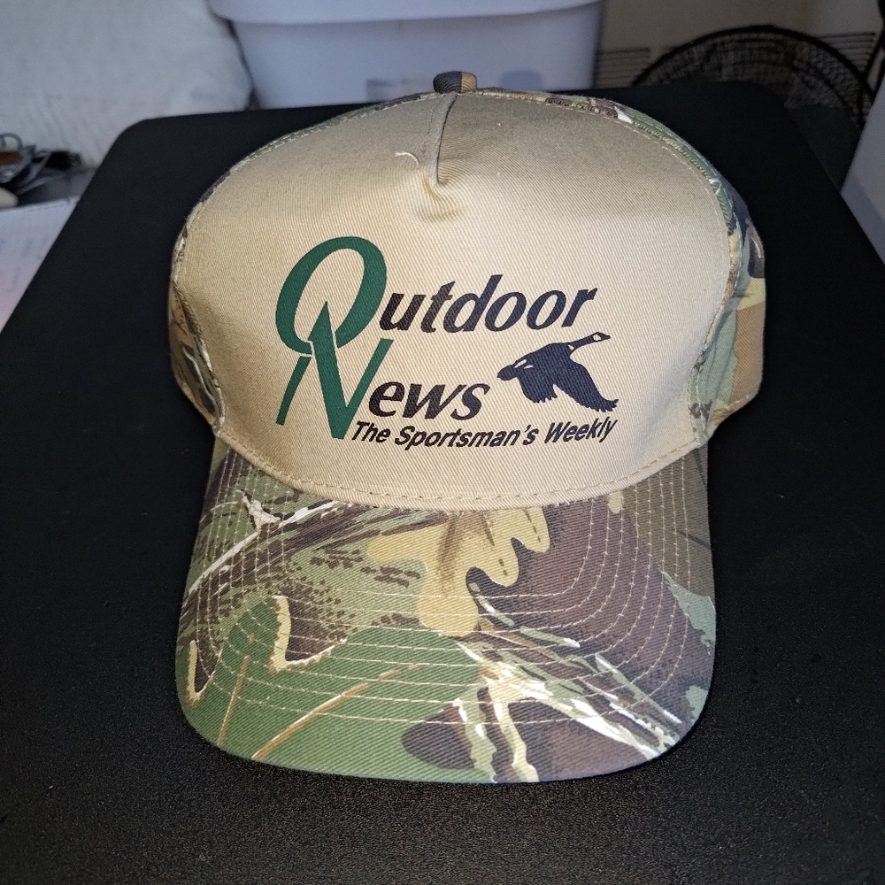 The Outdoor News The Sportsman's Weekly Camo Strap-on Hat Cap